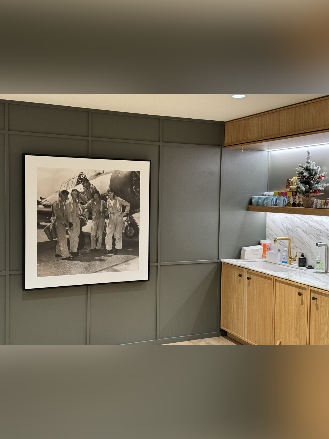 Modern kitchen corner with a black and white photo on the wall.