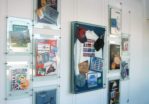 Display of framed memorabilia on white wall.