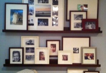 Framed family photos displayed on wall shelves.