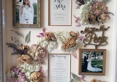 Wedding shadow box with photos and flowers.