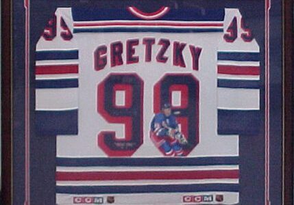 Framed hockey jersey with number 99.