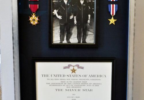 Military medals and framed photograph display.