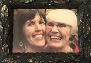 Smiling women in decorative black frame.