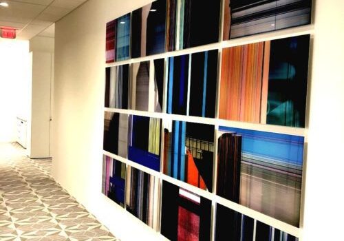 Colorful abstract wall art in hallway.